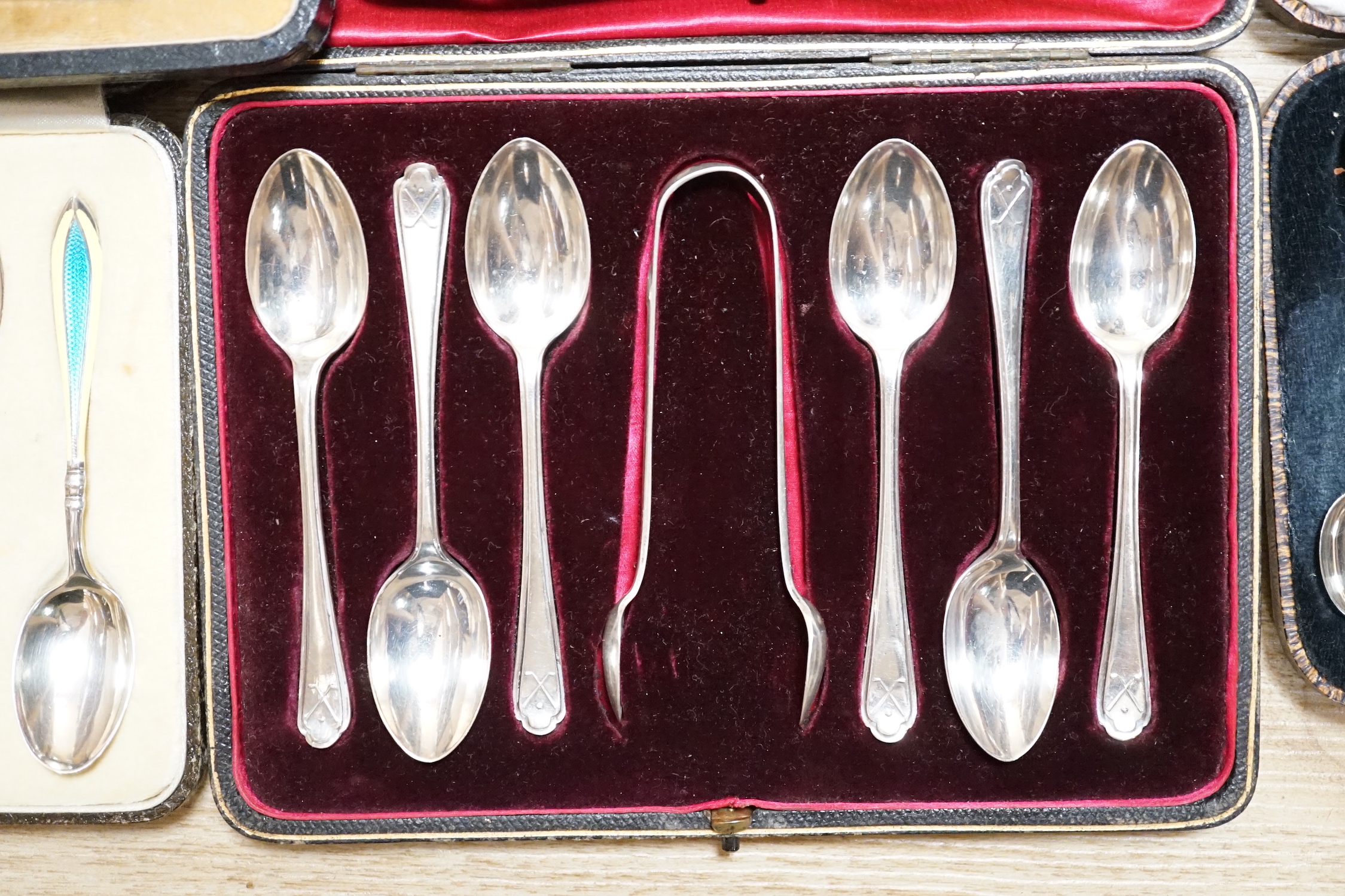 A cased set of six George V silver and polychrome enamel coffee spoons, Barker Brothers Silver Ltd, Birmingham, 1932, four other cased sets including teaspoons and tea knives and seventeen assorted Towle sterling handled